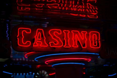 Casino Trip with Fun Scarf with a pocket - Neon Red and Blue Sign that spells out Casino.