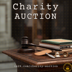 Charity Auction - There is podium top with various auction items on it. a gavel, signal paddle, and files.